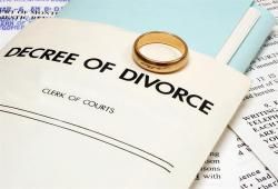 Decree of divorce with a wedding ring sitting on it