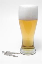 Glass of beer with car keys next to it